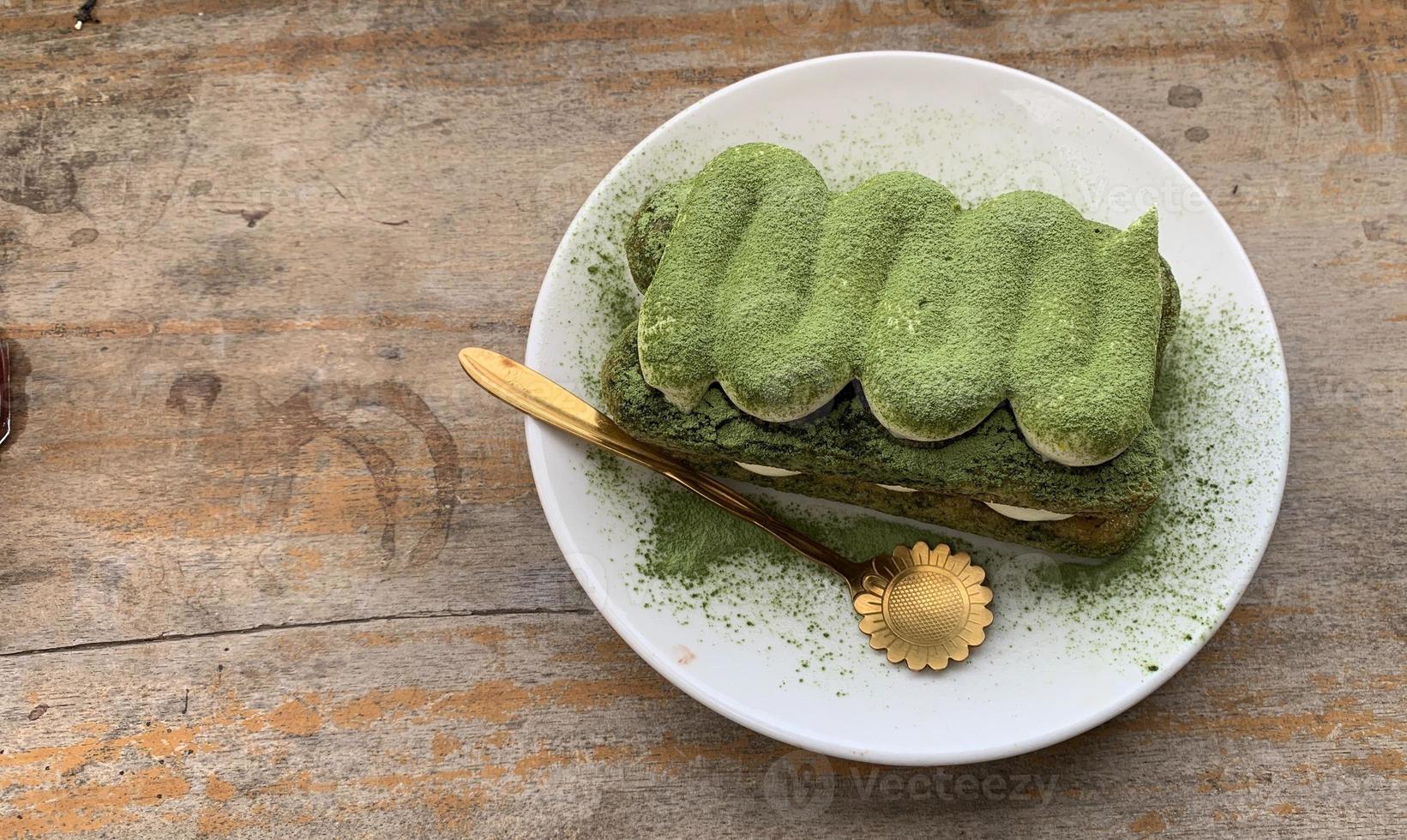 Tiramisu matcha served on a wooden table photo