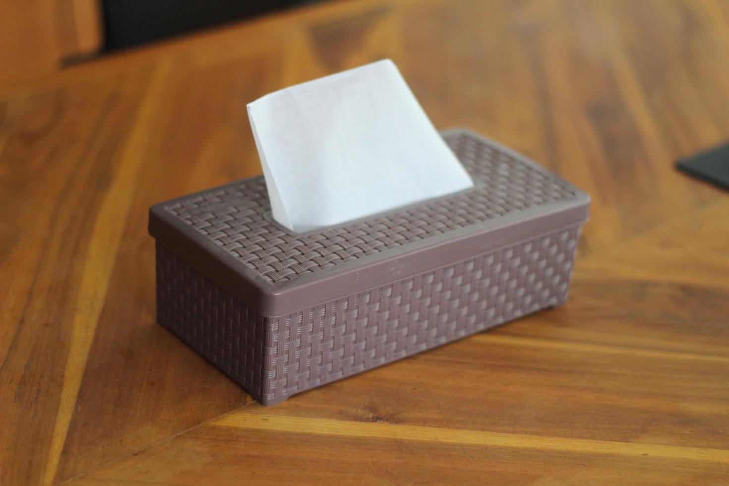 Brown tissue box on a wooden table photo