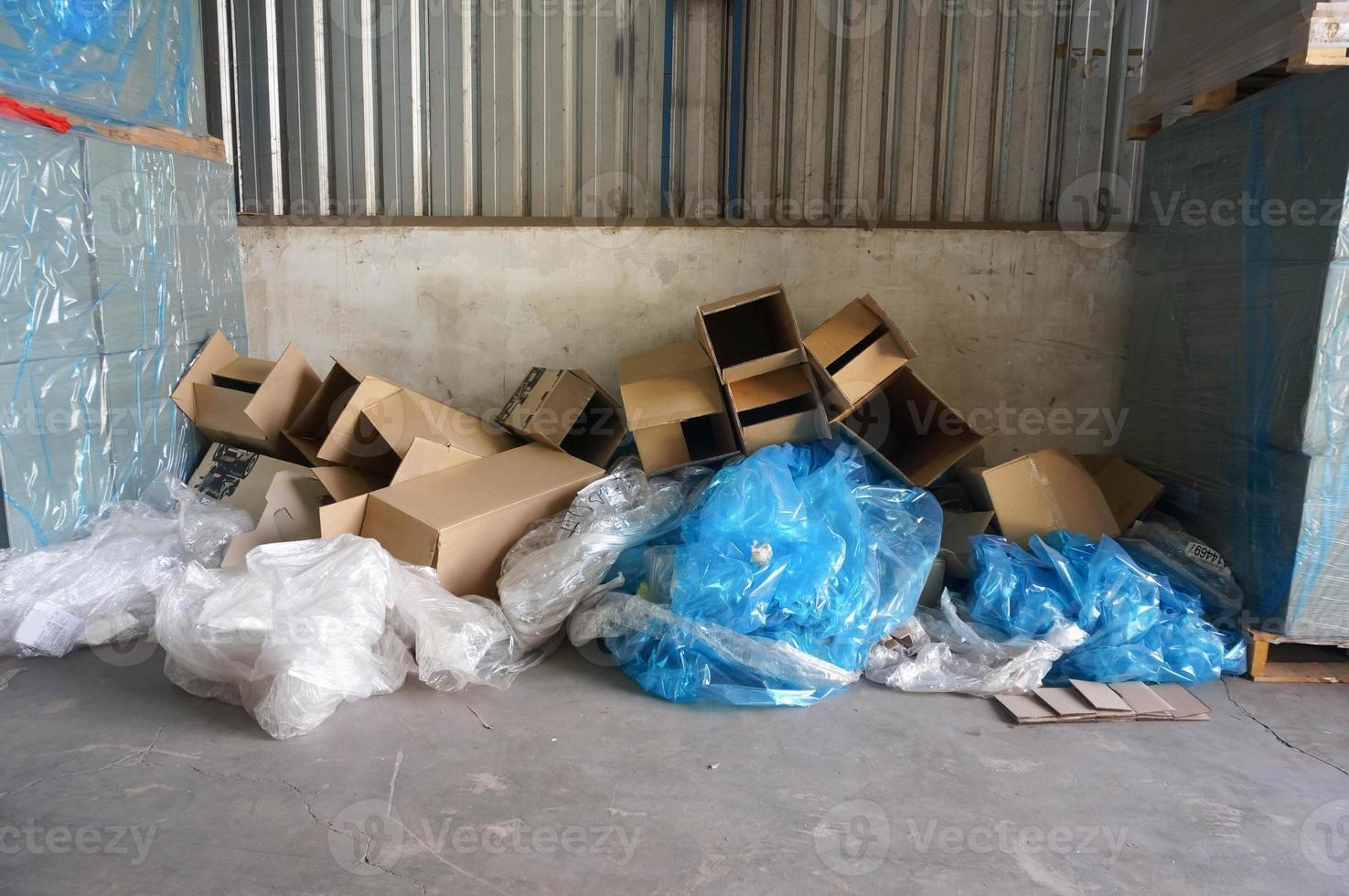 Waste cardboard and plastic in a warehouse. photo