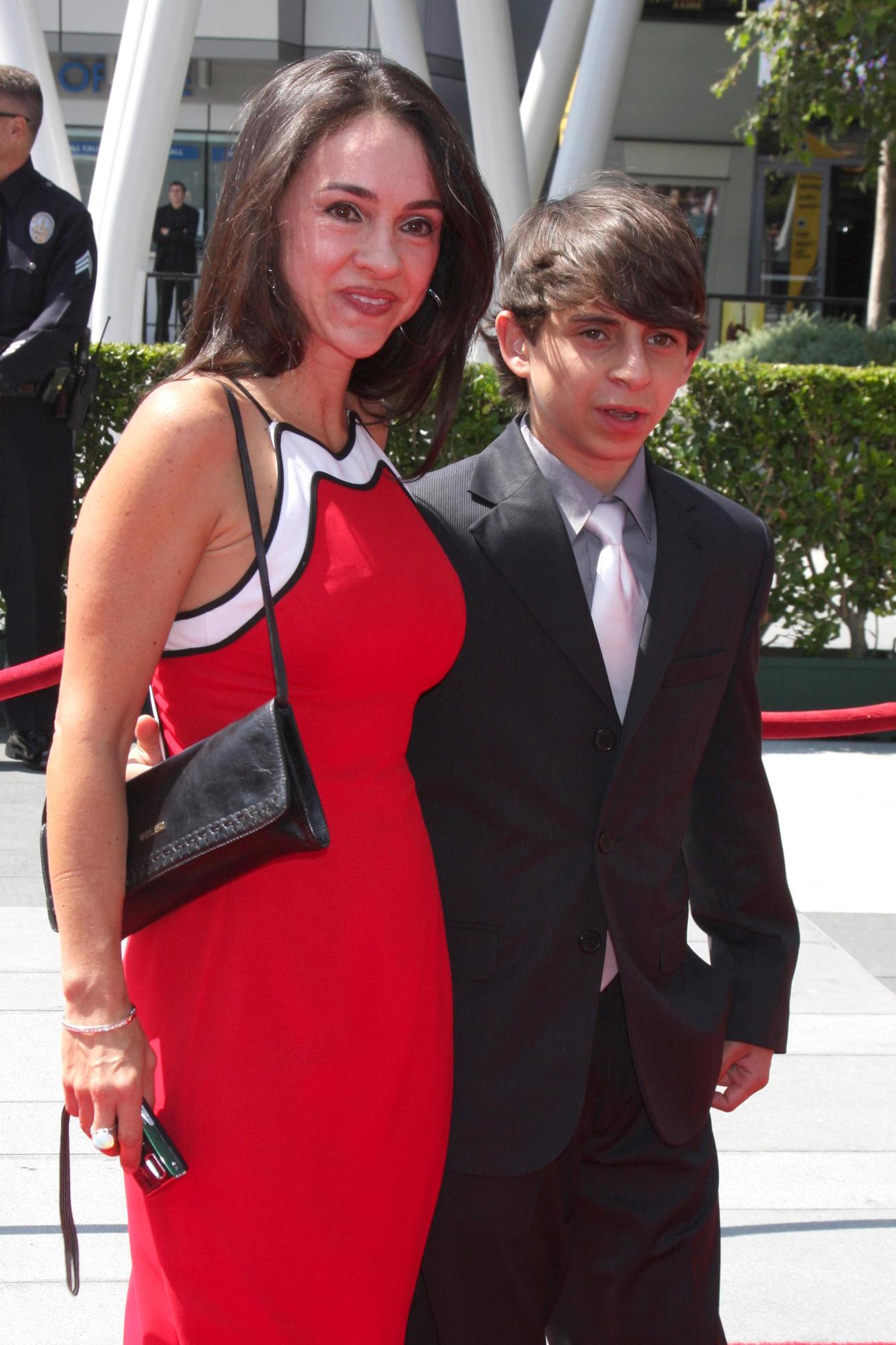Moises Arias with mother arriving at the Primetime Creative Emmy Awards at  Nokia Center in Los Angeles, CA on September 12, 2009 14688346 Stock Photo  at Vecteezy