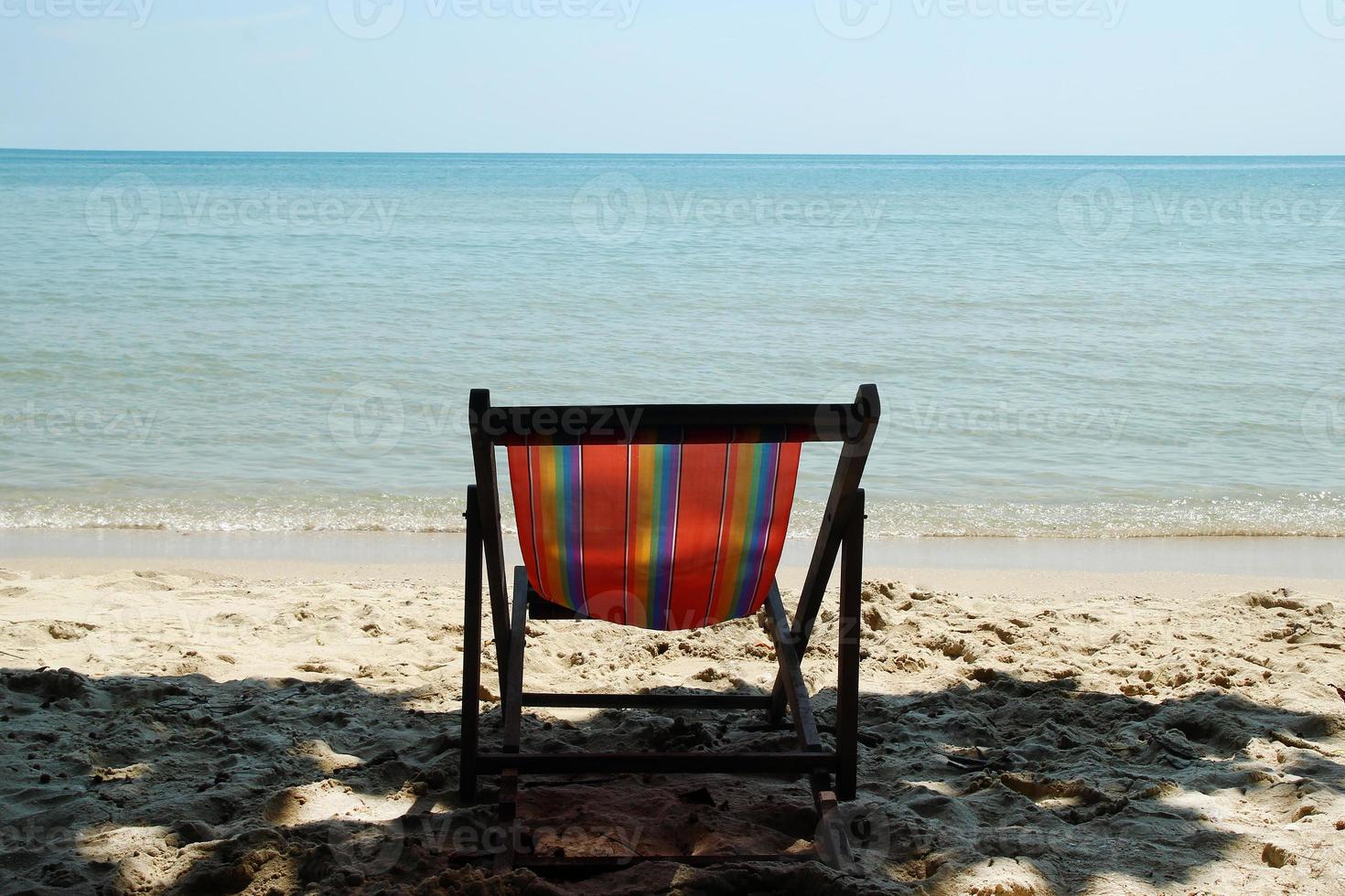 Colorful beach chair on a sandy beach near to the sea. Koh Chang, Thailand. photo