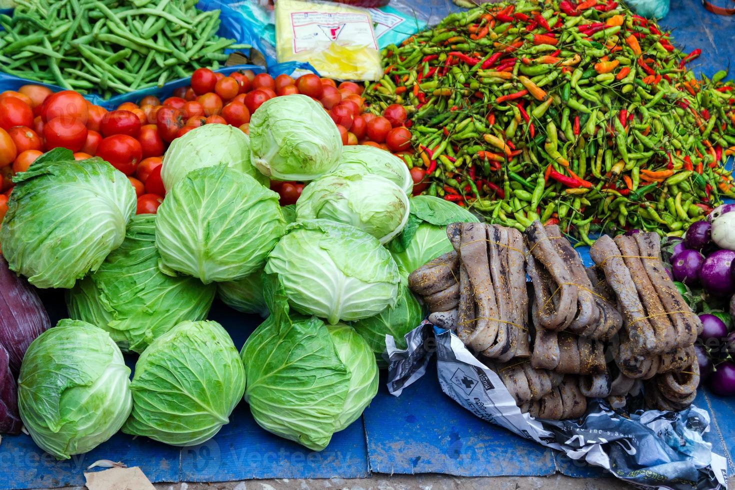 Fresh tropical vegetables and dried squids on street market. Local morning market in Luang Prabang, Laos. photo