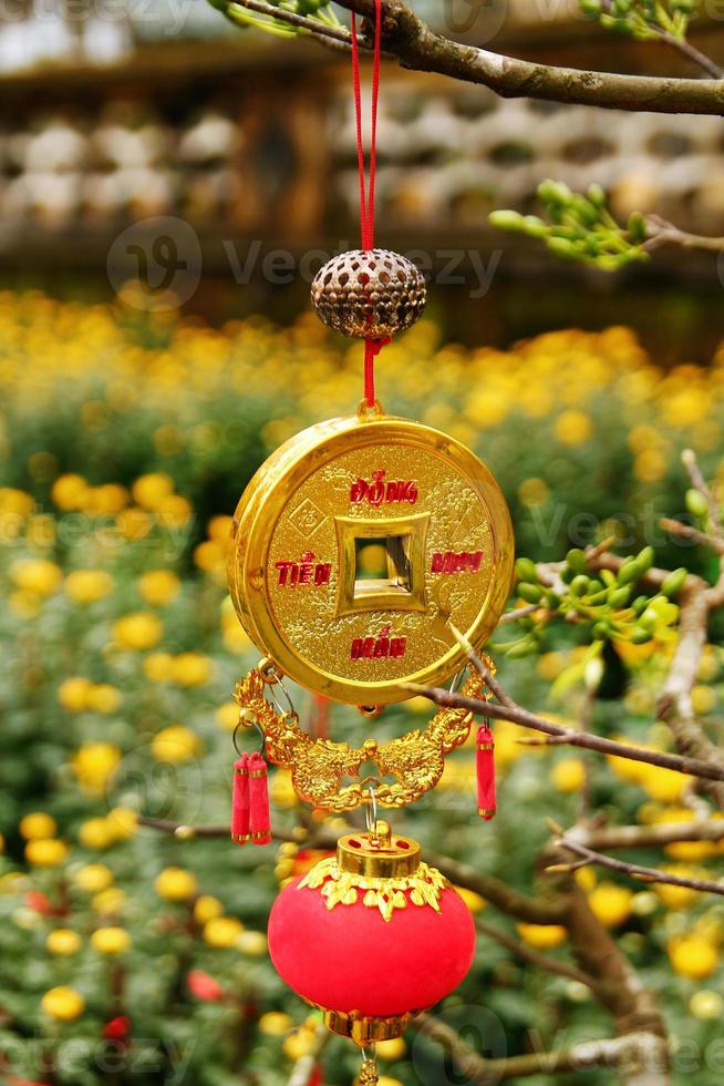 Vietnamese New Year decoration on a blurred background of yellow flowers. Hue, Vietnam. photo