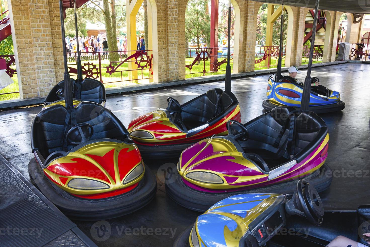 Colorful bumper cars, racing cars in amusement park, racing with bumps photo