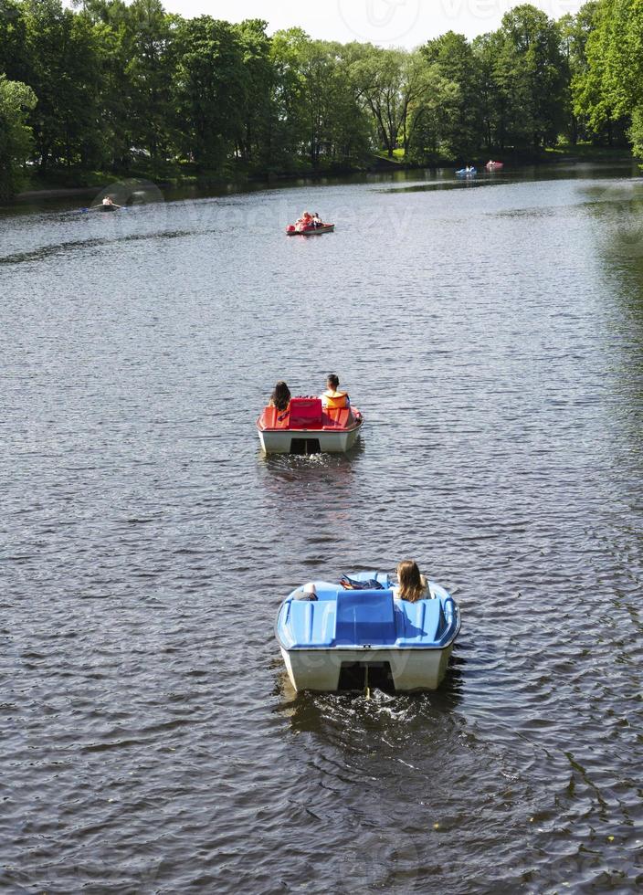 catamaran riding in the park on the lake, a young couple in love riding a catamaran, relaxing on the water at the weekend photo