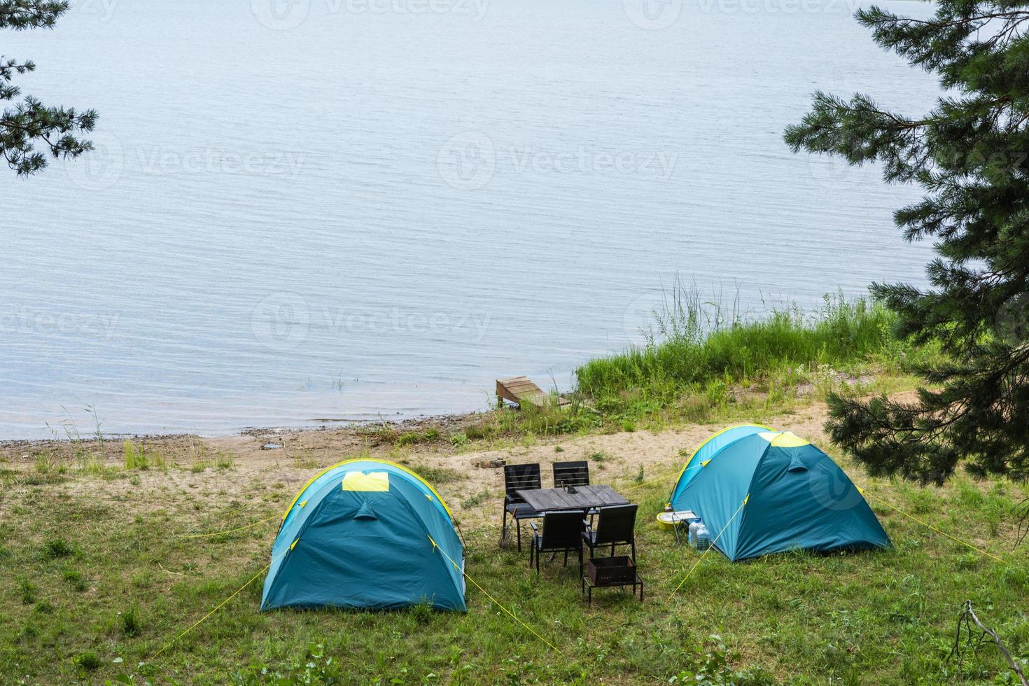 Tourist tents for camping on the lake shore, travel history. fishing, tourism, active recreation. Natural landscape. For lifestyle design. Outdoor recreation photo