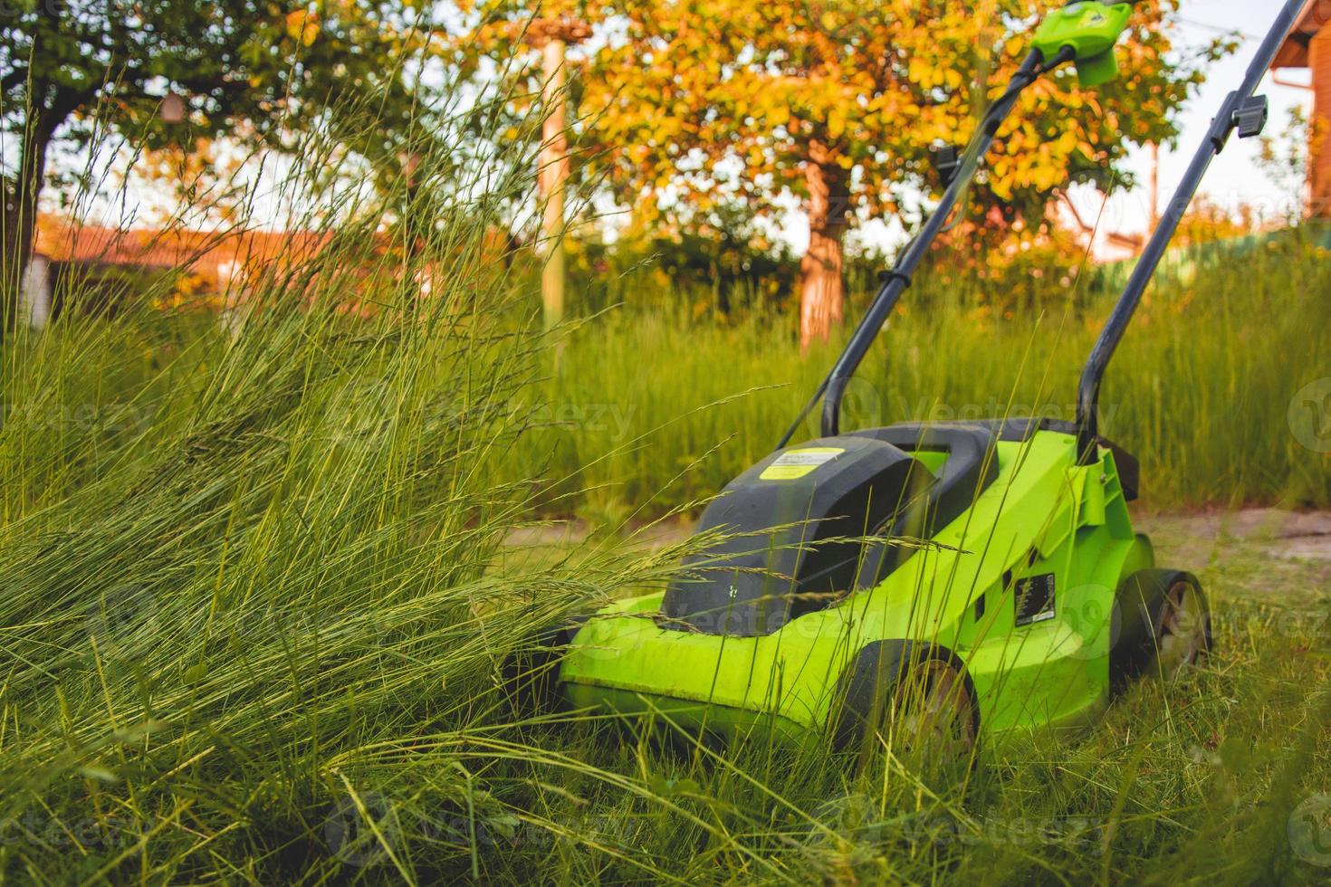 lawn mower on the grass, lawn care, mowing the grass, country cares, lawn mowing with an electric lawn mower photo