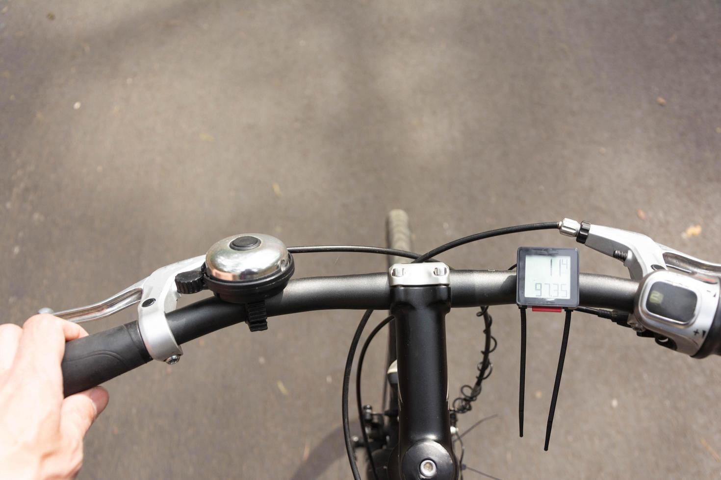 bicycle handlebar while driving, first-person view of the bicycle handlebar and the road while riding photo