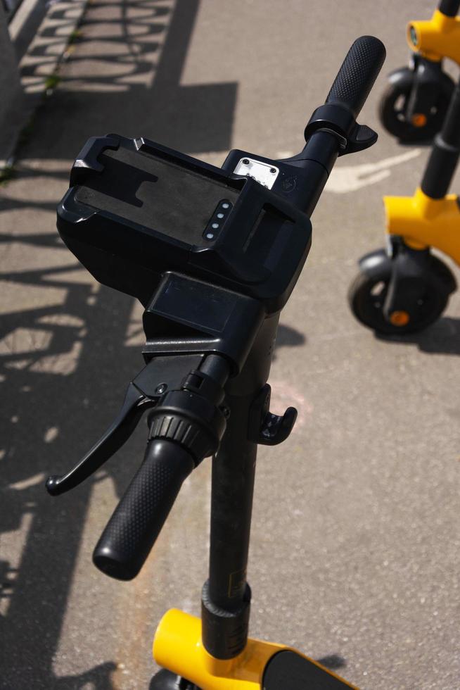 electric scooters parked on the street in the summer, electric scooter rental, electric scooter ride in the park in the summer, steering wheel photo