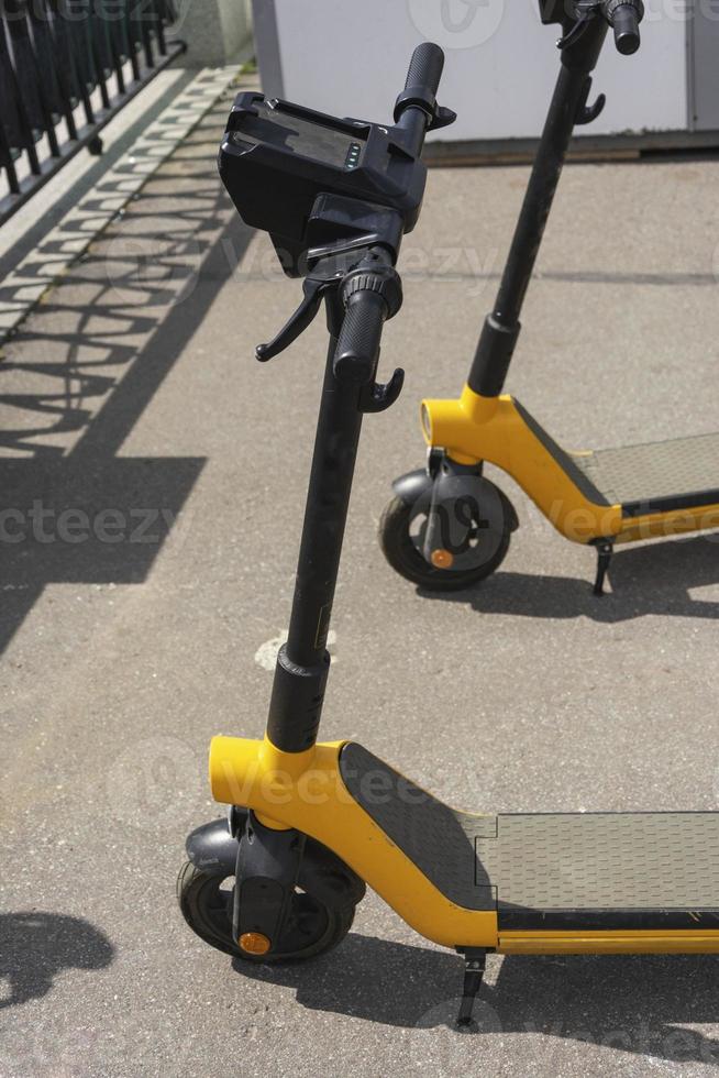 electric scooters parked on the street in the summer, electric scooter rental, electric scooter ride in the park in the summer, steering wheel photo