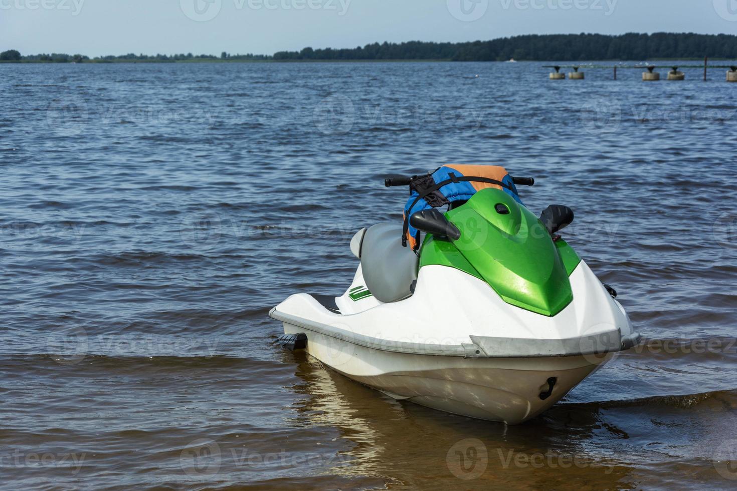 Beautiful green jet ski on the lake, jet skiing, active lifestyle, summer, water, heat, vacation photo