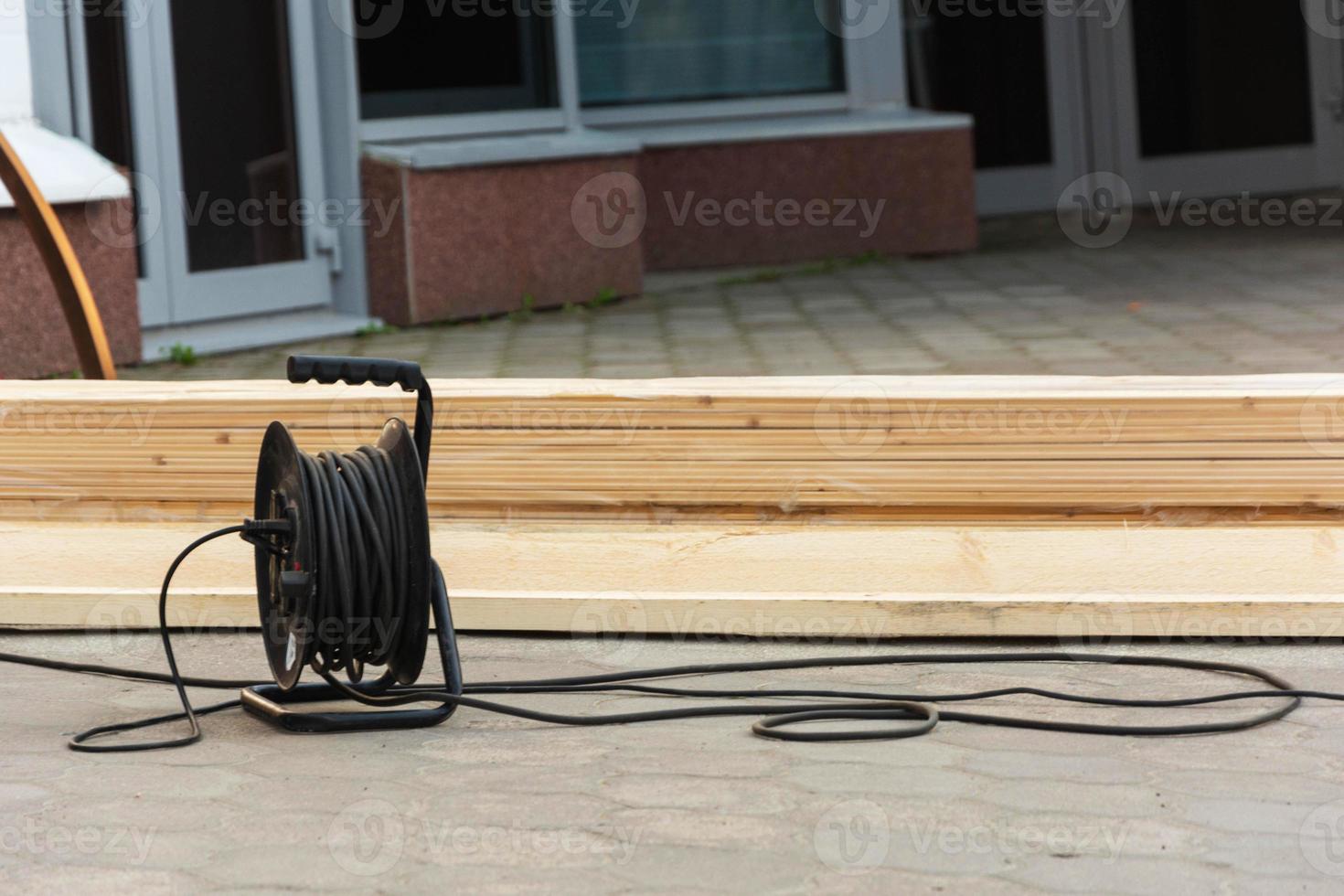 electric extension coil, cable, boards on the construction site, construction, repair photo