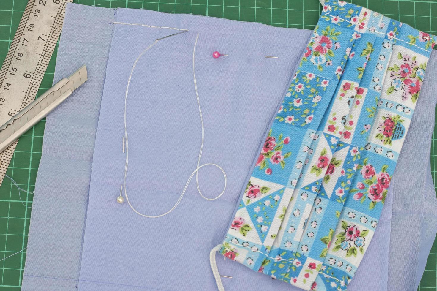 Sew the fabric mask by hand to prevent the Novel Coronavirus 2019 or Covid-19. Due to the scarce hygienic mask. photo