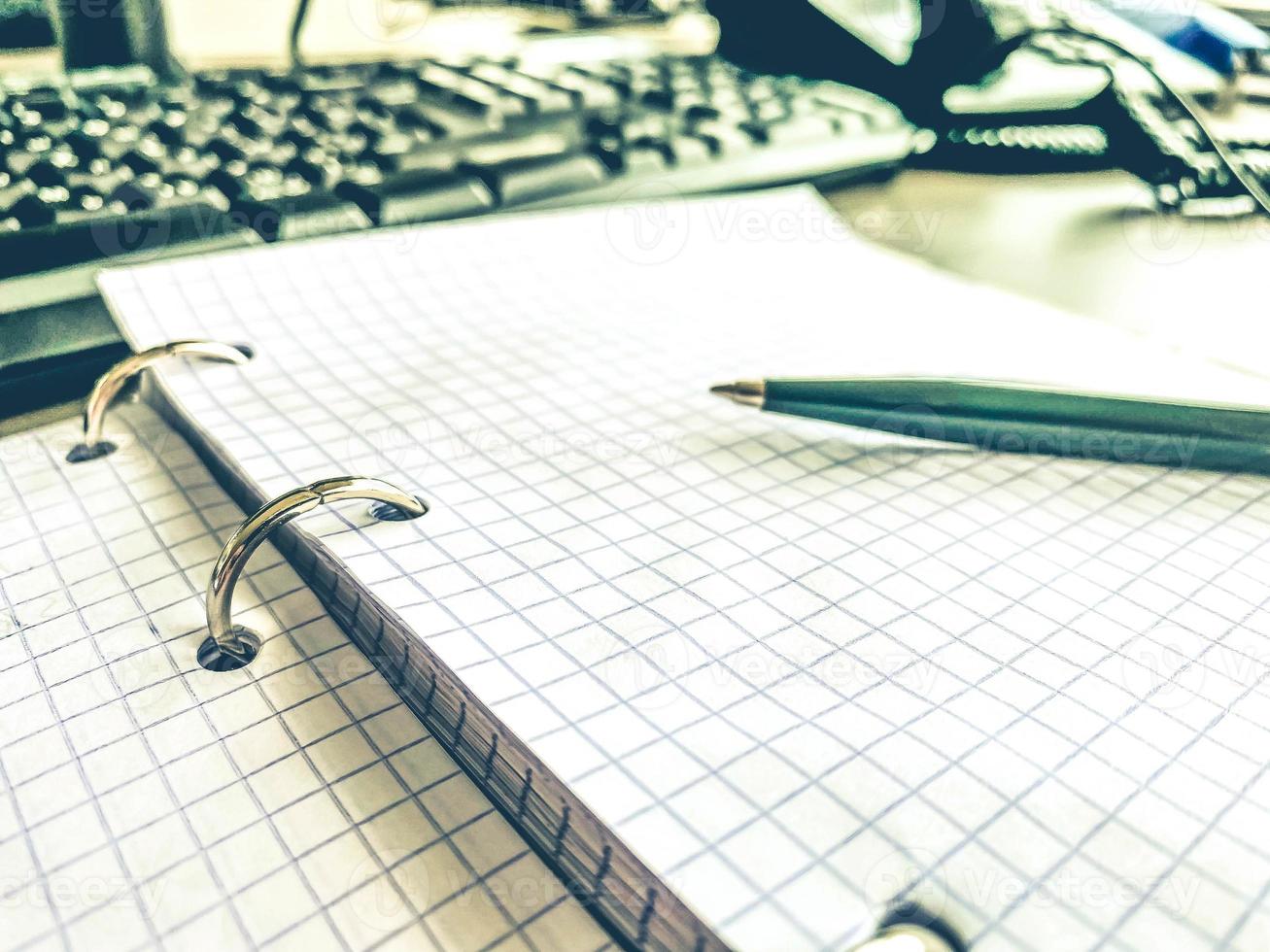 a sheet of white paper in a cage from a notebook. diary to record all personal affairs and tasks. lined sheet of paper. retro notepad, note taking on a sheet photo