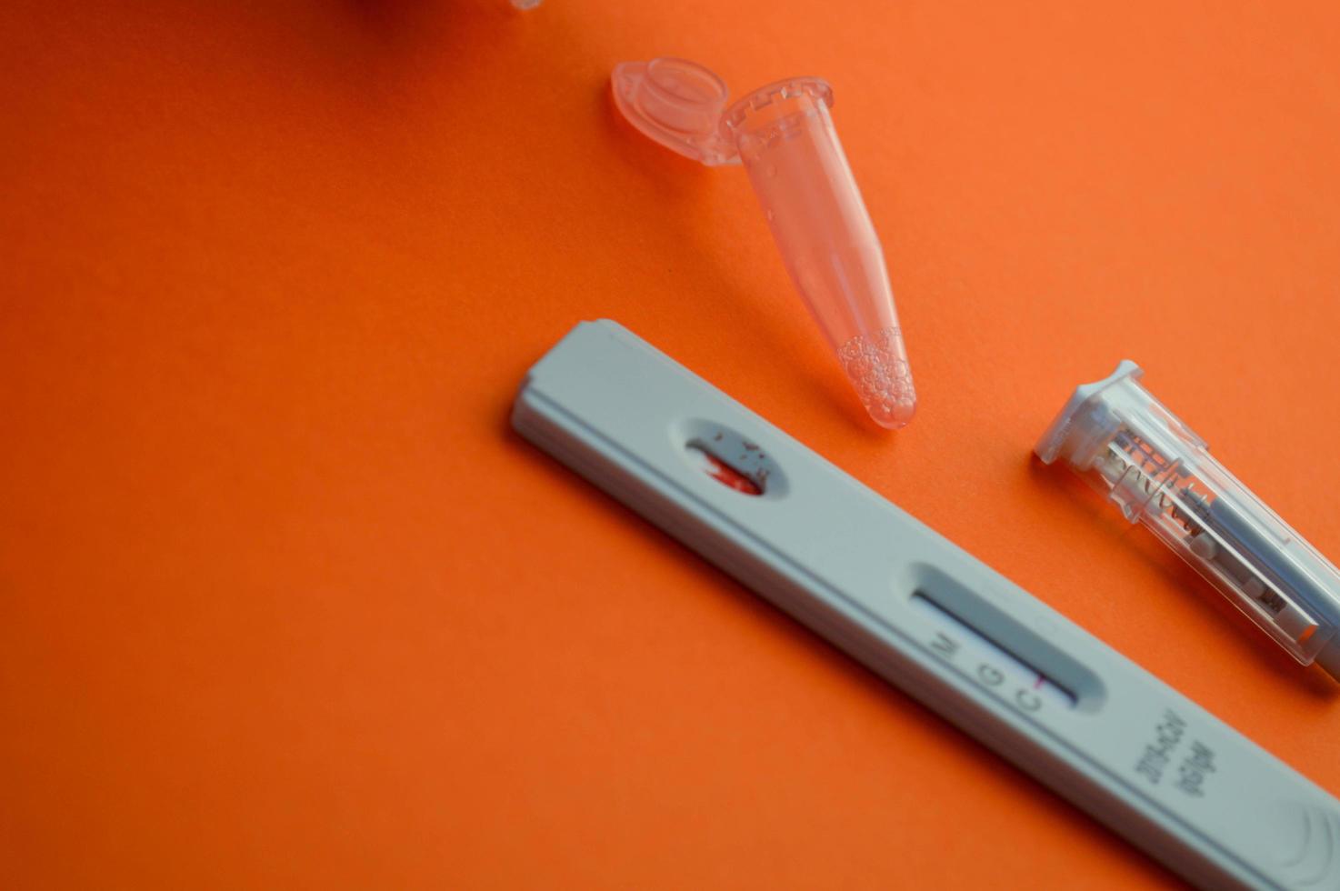 Negative test for antibodies to covid-19 virus. Bright orange table, copy space photo