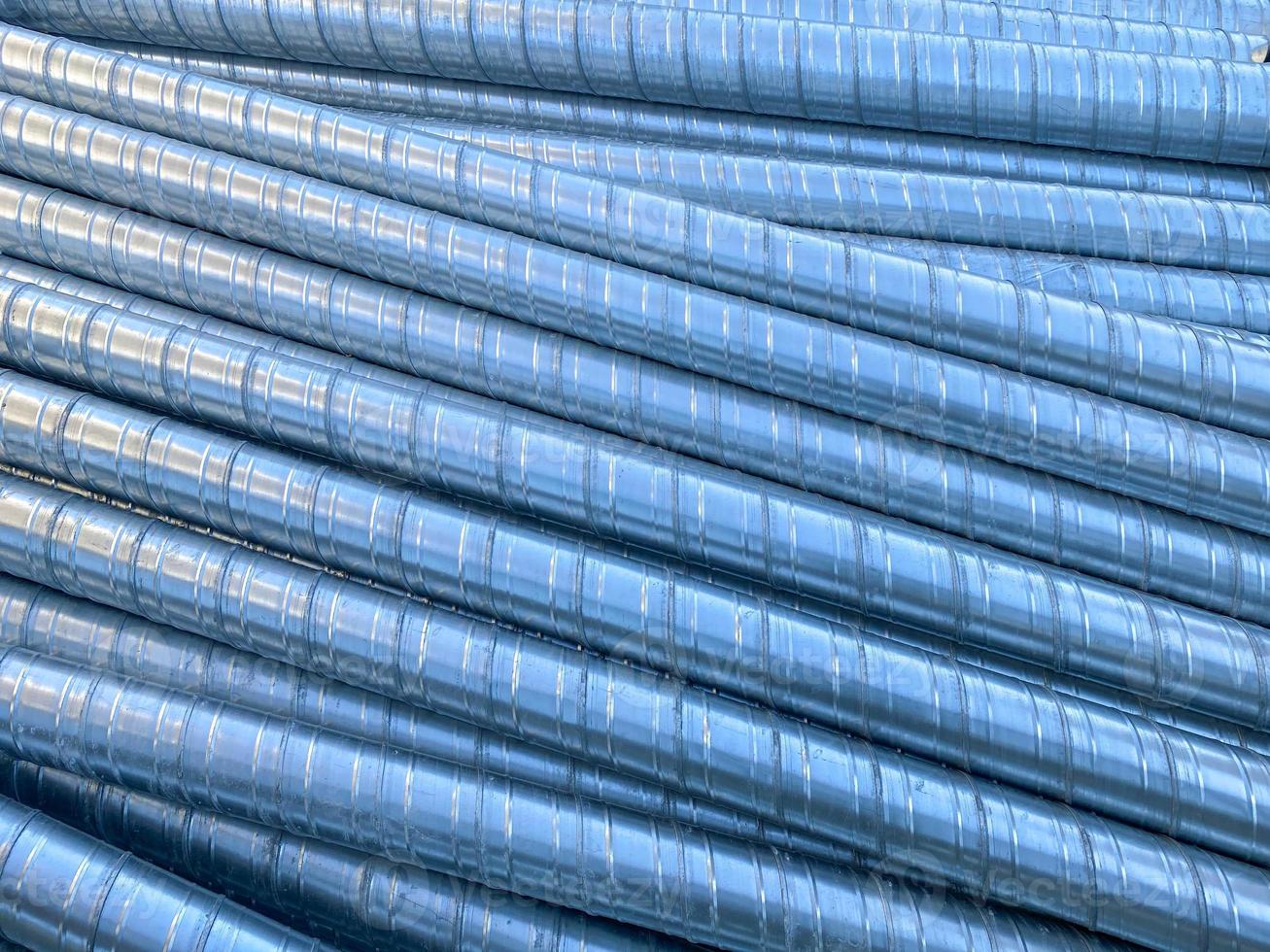 Shiny metal industrial stainless steel pipes for ventilation on a construction site. The background. Texture photo