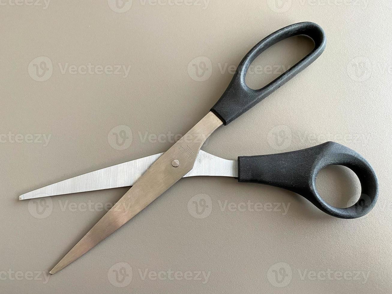 Black metal sharp scissors for paper on the working office table. Business work photo