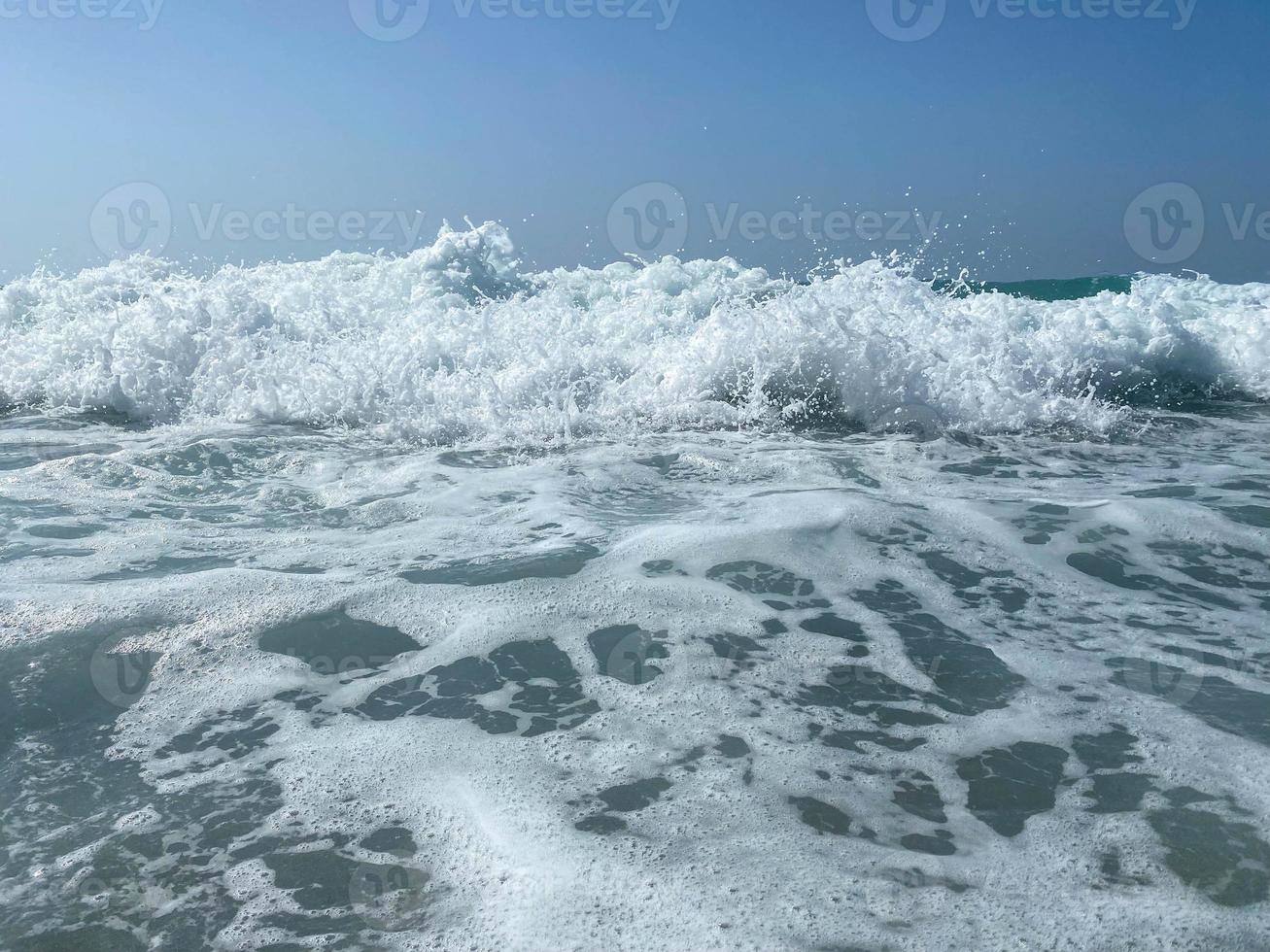 Beautiful sea with waves splashing warm sparkling clear blue water in a warm tropical oriental country southern resort. Background, texture photo