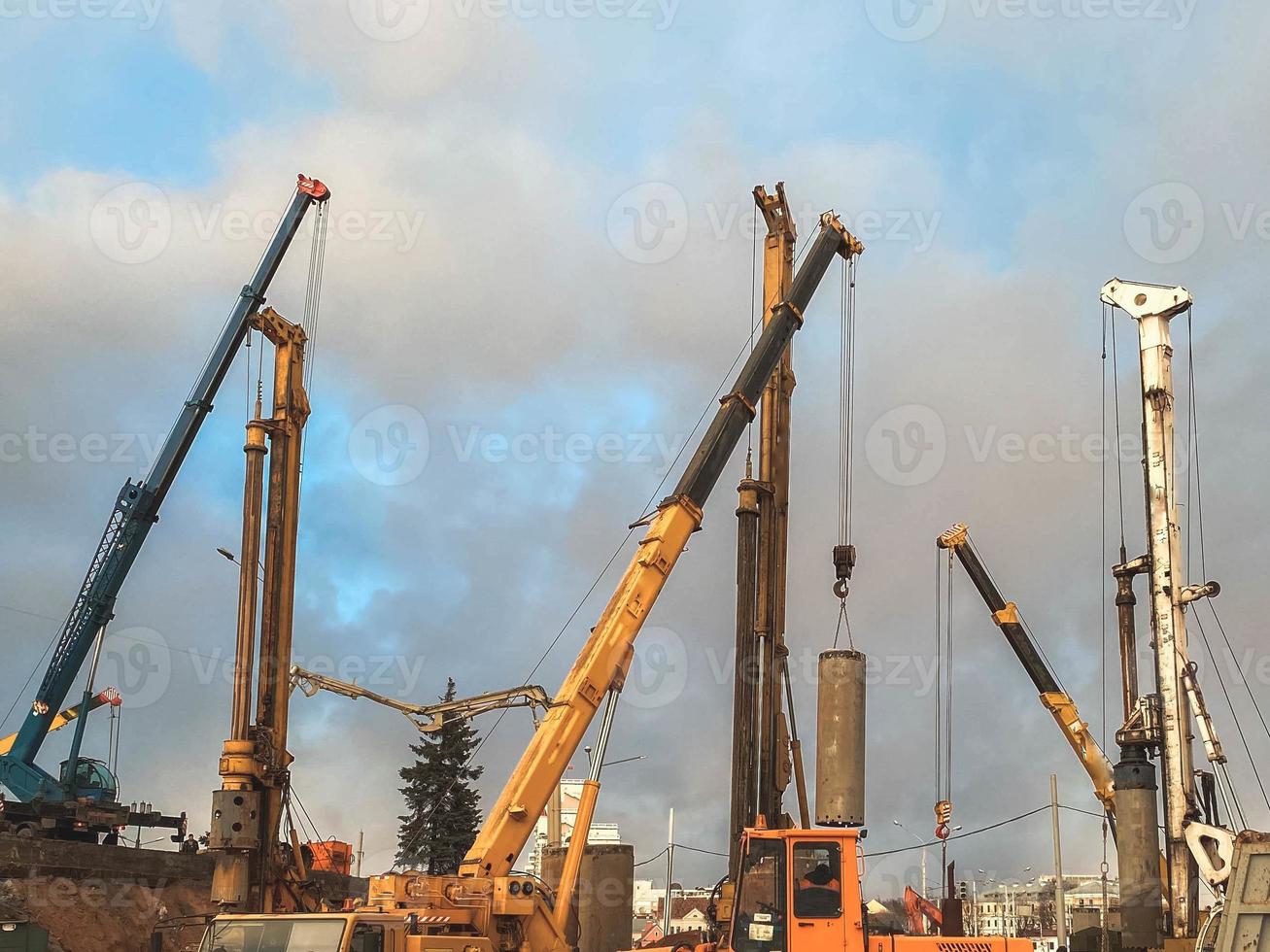 construction equipment at the overpass repair site. large concrete blocks are erected by cranes and other construction equipment. repair of the bridge in the city center photo