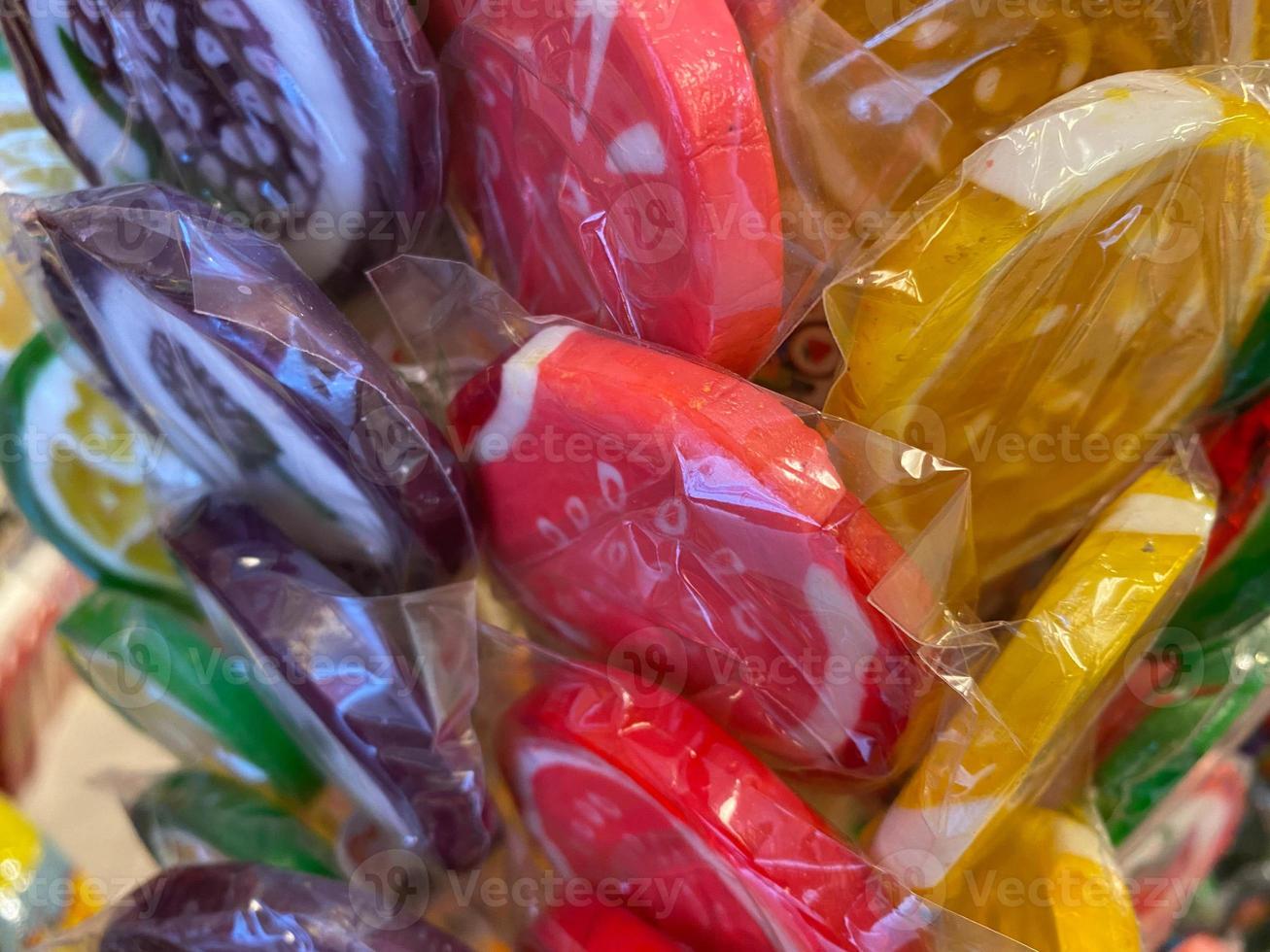 Colorful lollipops on stick for sale in shop window photo