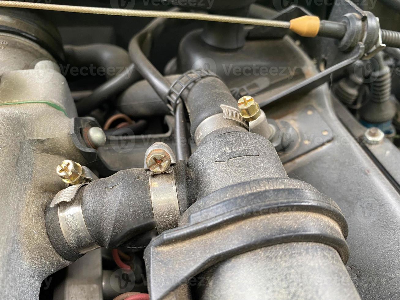 Alternator. Dusty details of a flat-four boxer car engine compartment under the open hood. Closeup side view photo