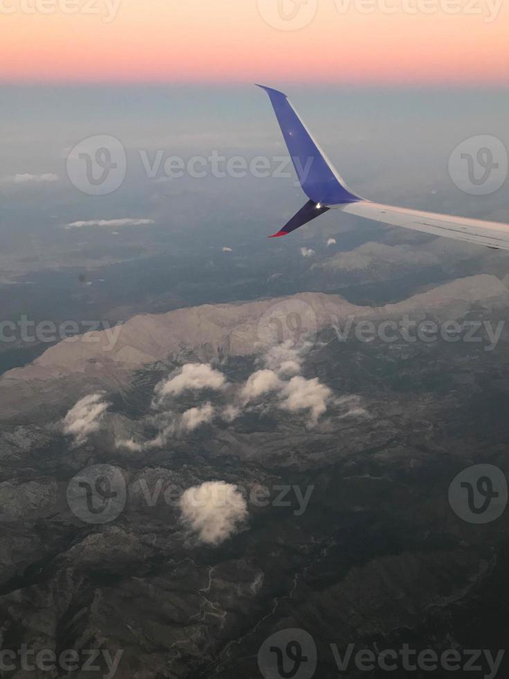 View of the clouds and airplane wing from the Inside photo