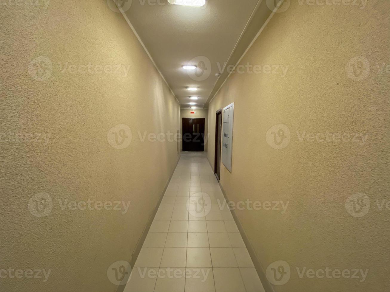 Long Corridor With Metal Doors, Tilled Wall And Floor photo