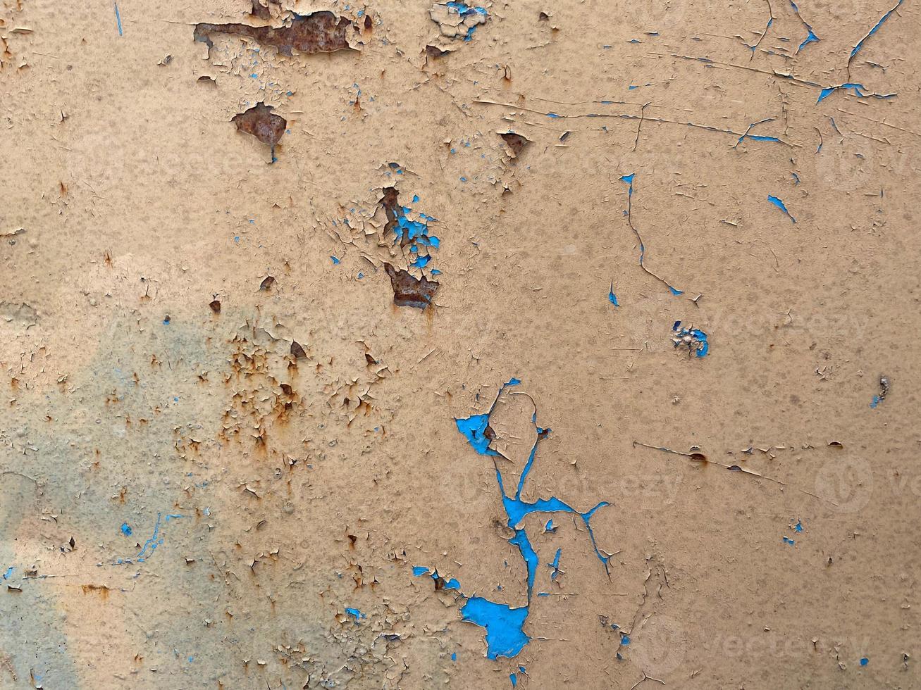 Yellow and blue old scratched metal sheet, iron rusty surface with peeling paint. The background. Texture photo