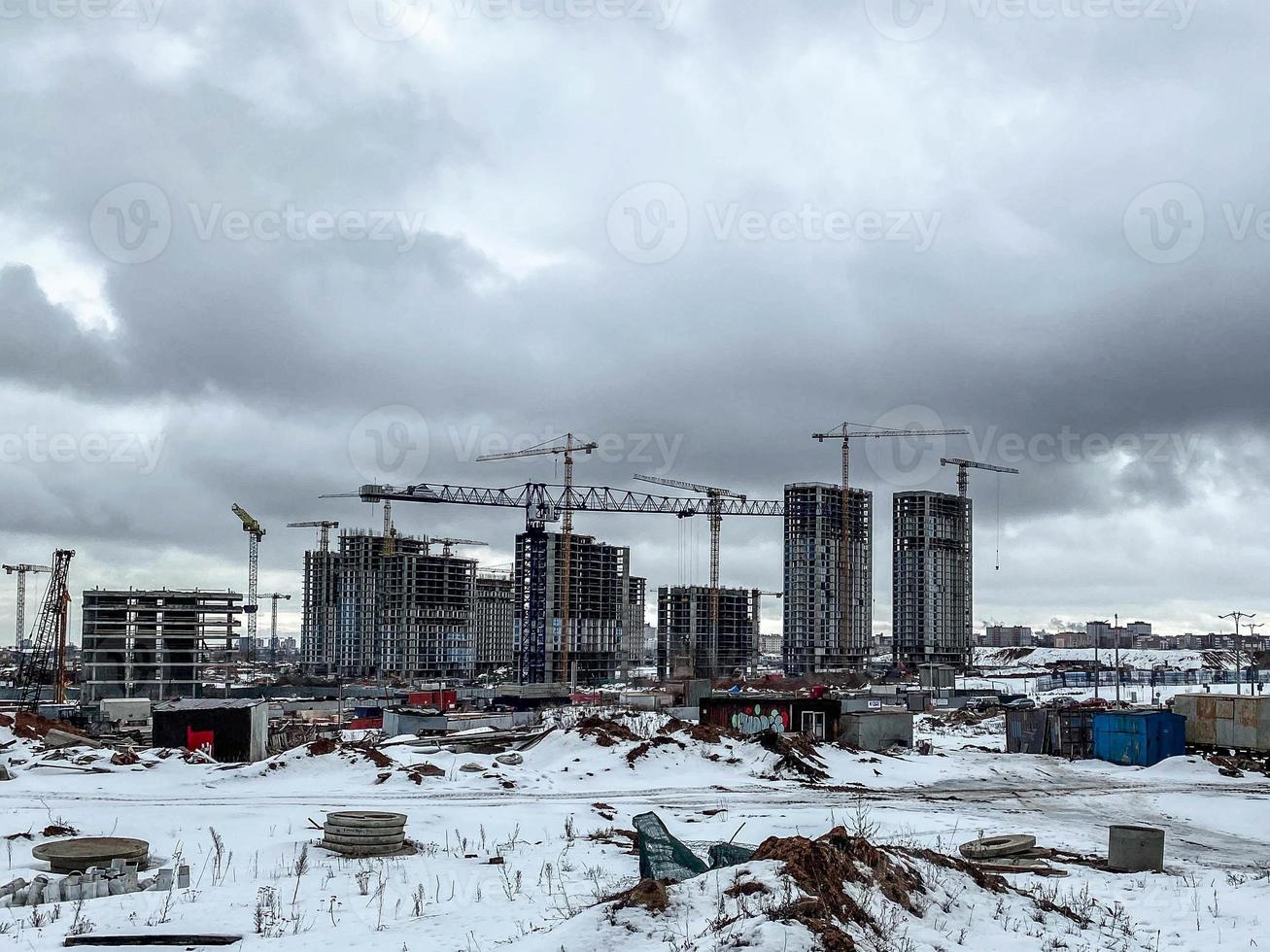 construction of houses, a shopping center from concrete blocks in the city. construction of a new residential area in the winter on the outskirts of the city. block of high-rise buildings photo