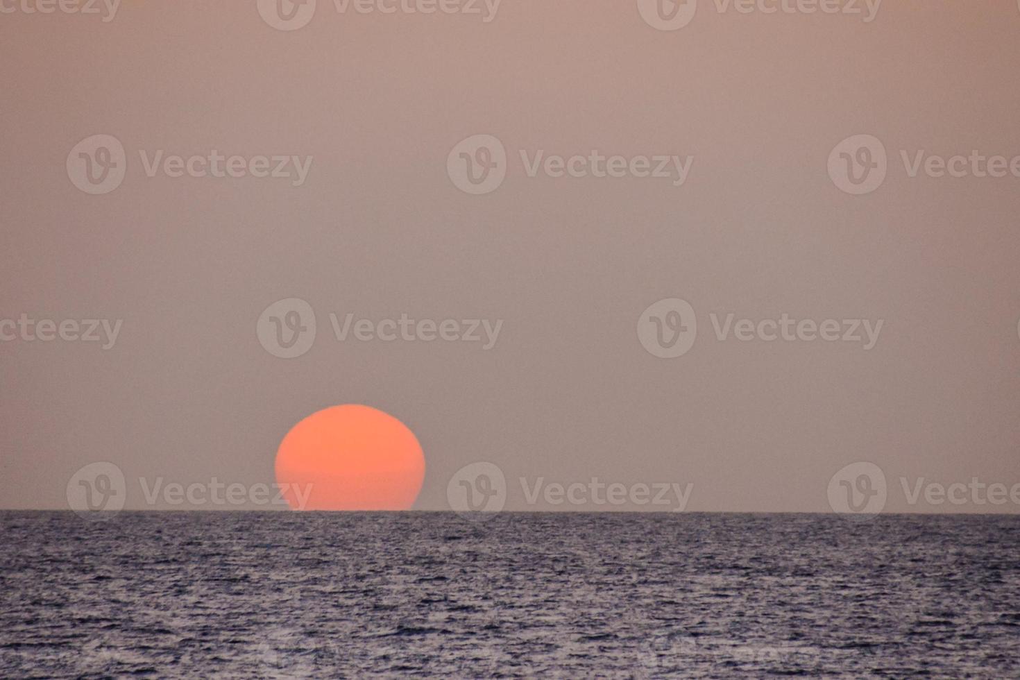 Sunset over the ocean photo