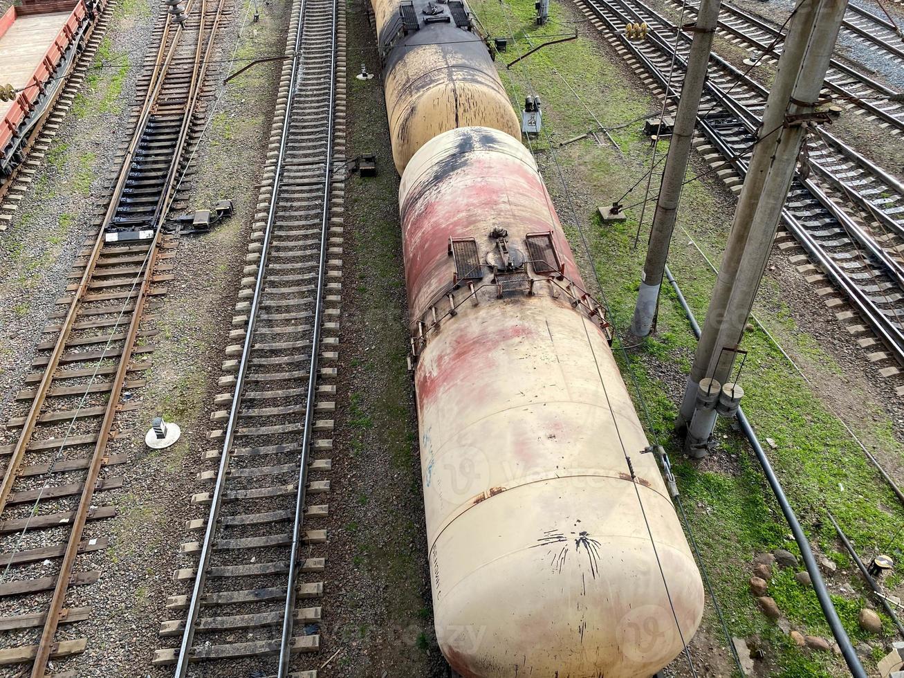 Top view of different railway wagons and tanks on an industrial railroad with rails for the transport of goods and improved modern logistics photo