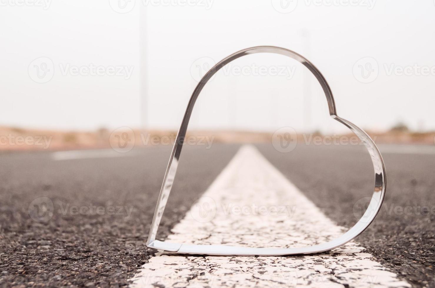 Heart metal shape on the ground photo