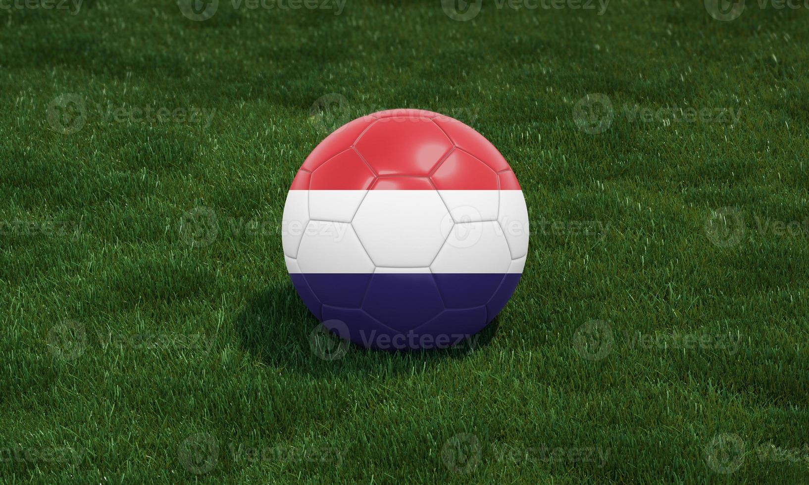 Soccer ball with Netherlands flag colors at a stadium on green grasses background. photo