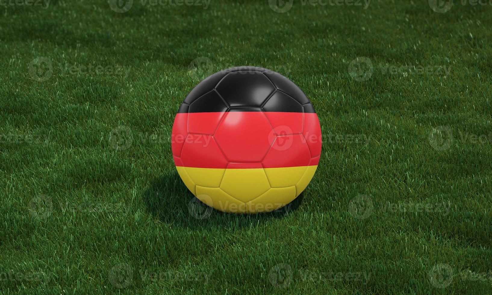 Soccer ball with Germany flag colors at a stadium on green grasses background. photo