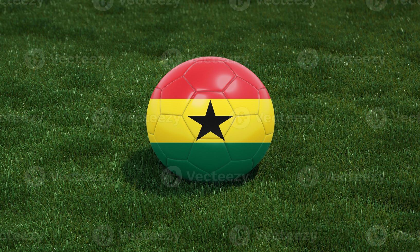 Soccer ball with Ghana flag colors at a stadium on green grasses background. photo