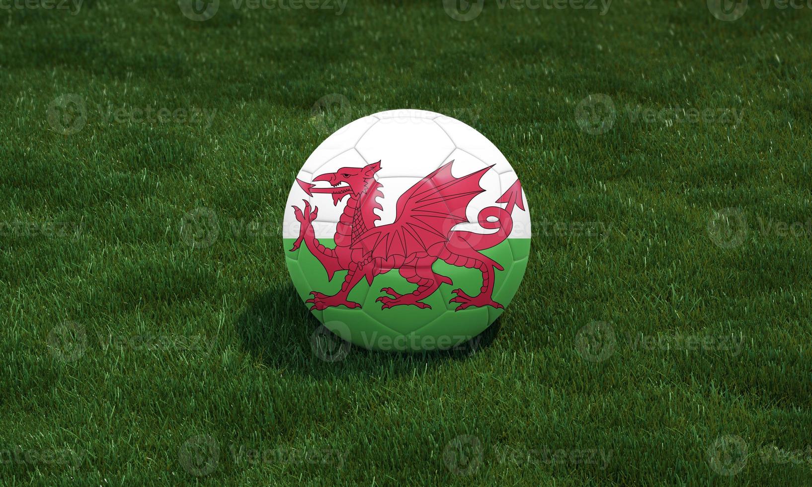 Soccer ball with Gales flag colors at a stadium on green grasses background. 3D illustration. photo