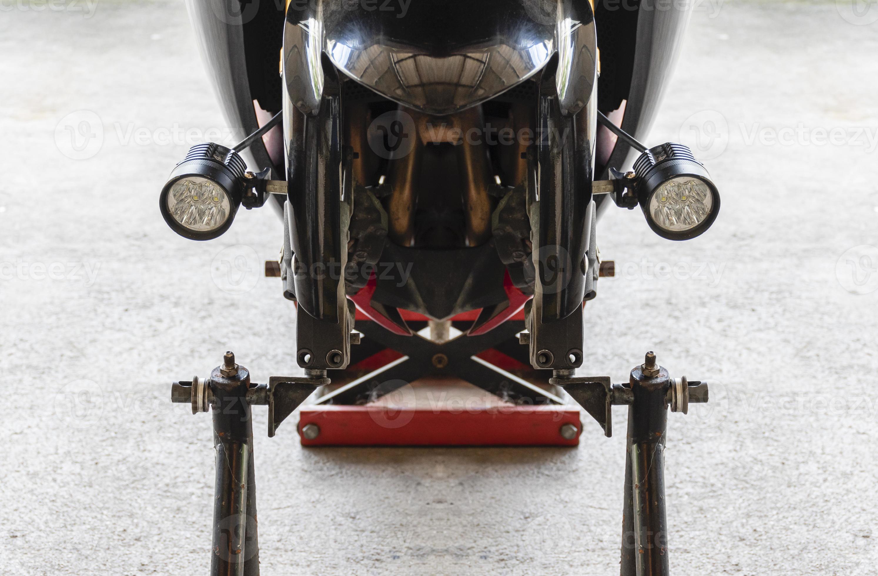 Front view motorcycle up to stand to remove wheel to change tire