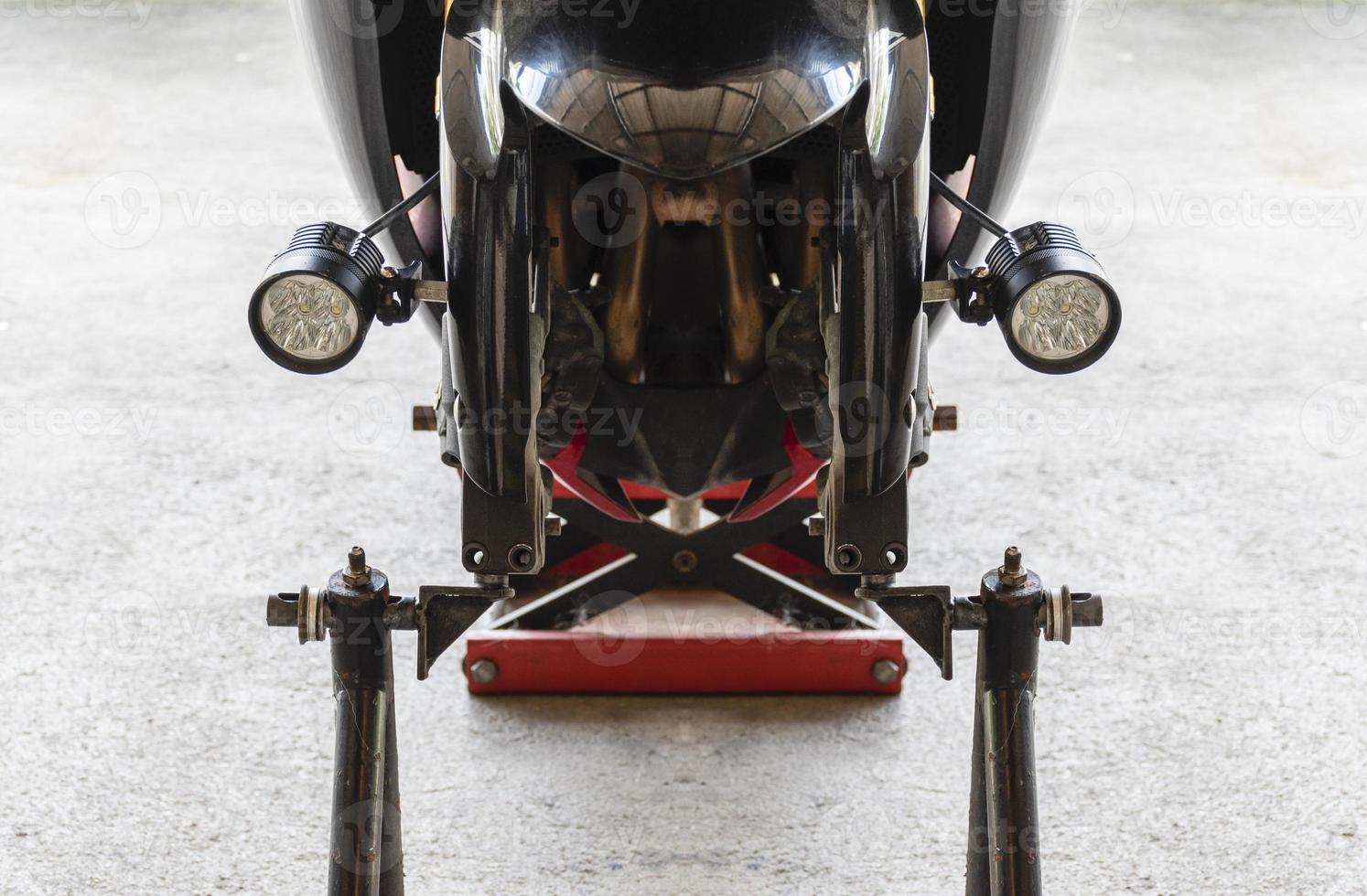 Front view motorcycle up to stand to remove wheel to change tire photo