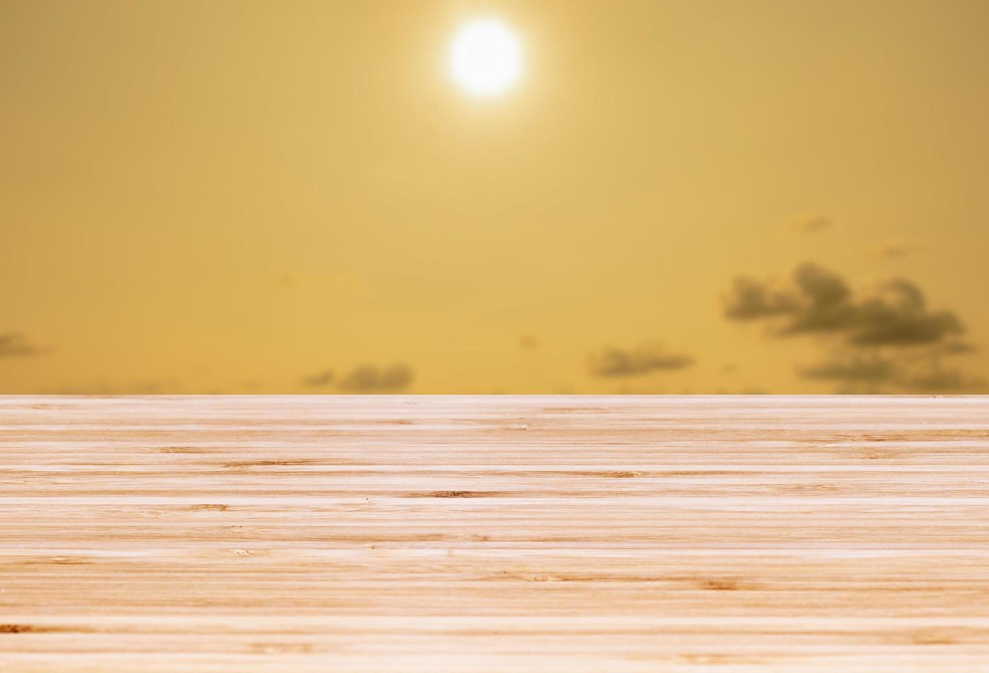 Template empty top table view with sunset time and yellow sky blur effect background photo