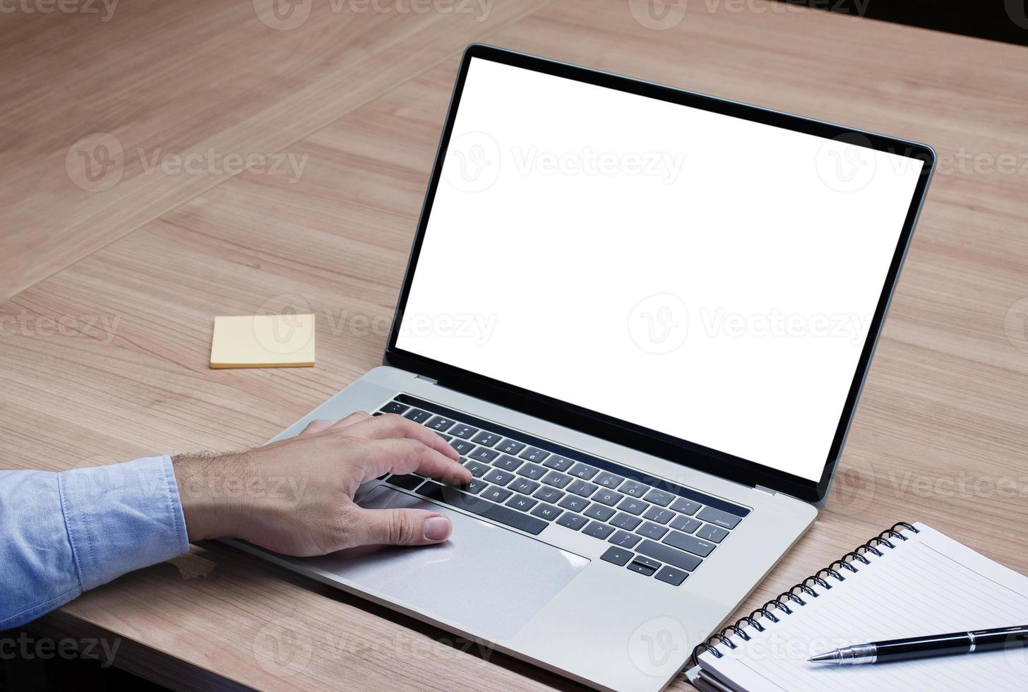 Businessman put your hand on keyboard and white screen background mock up on display laptop with clipping path photo