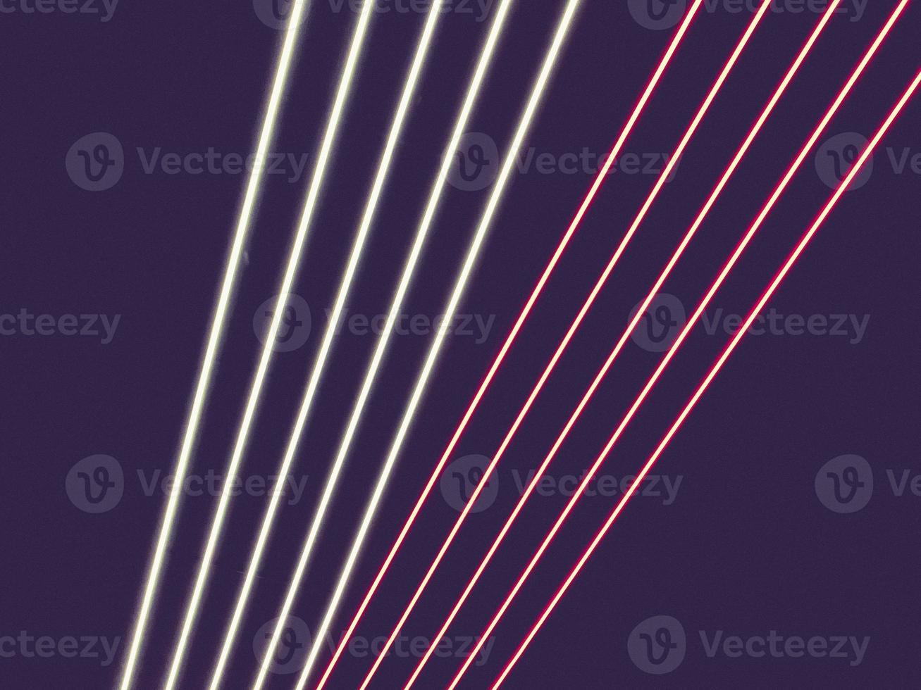 Texture of purple, pink and white glowing bright neon LED multicolored laser abstract stripes and lines from parallel lamps. The background photo