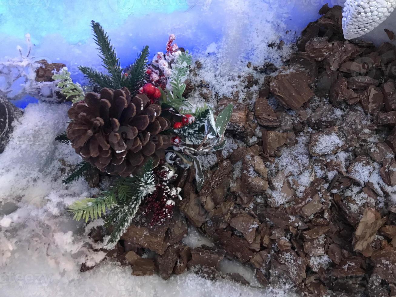 Christmas or New Year blurred snow background with festive fir tree and pine cones, selective focus photo