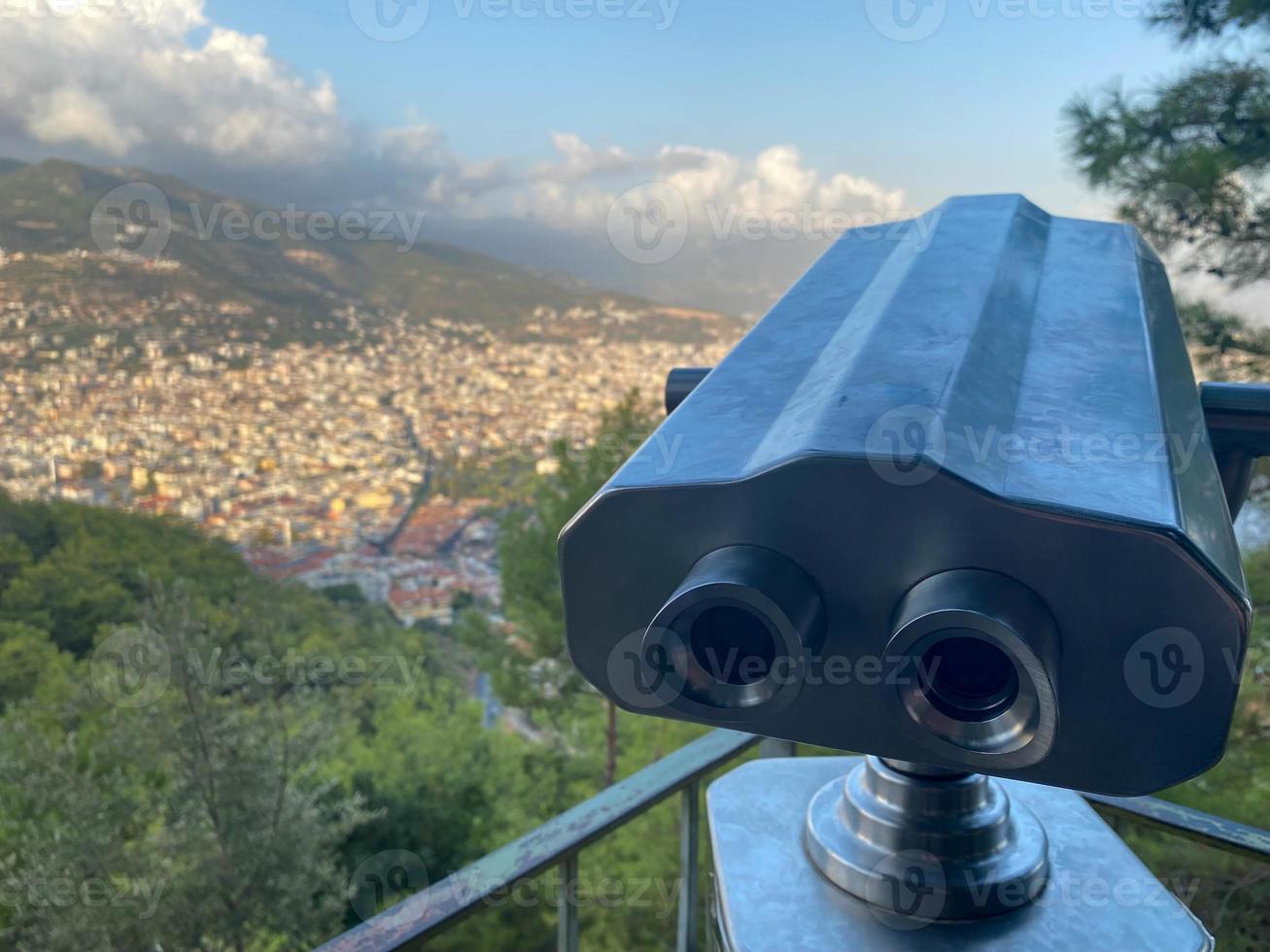 Binoculars, spyglass for observing the landscape and sights on an observation deck overlooking the city in a tourist warm tropical eastern country southern resort photo