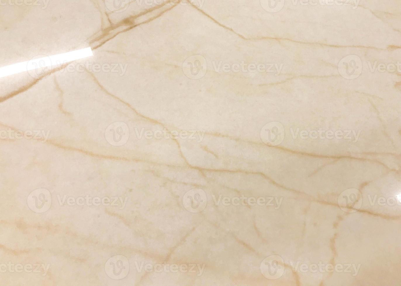 marbled texture. expensive material for covering walls and floors, tiles for applying in the bathroom and on the floor. uneven, smooth, shiny texture with beige streaks photo