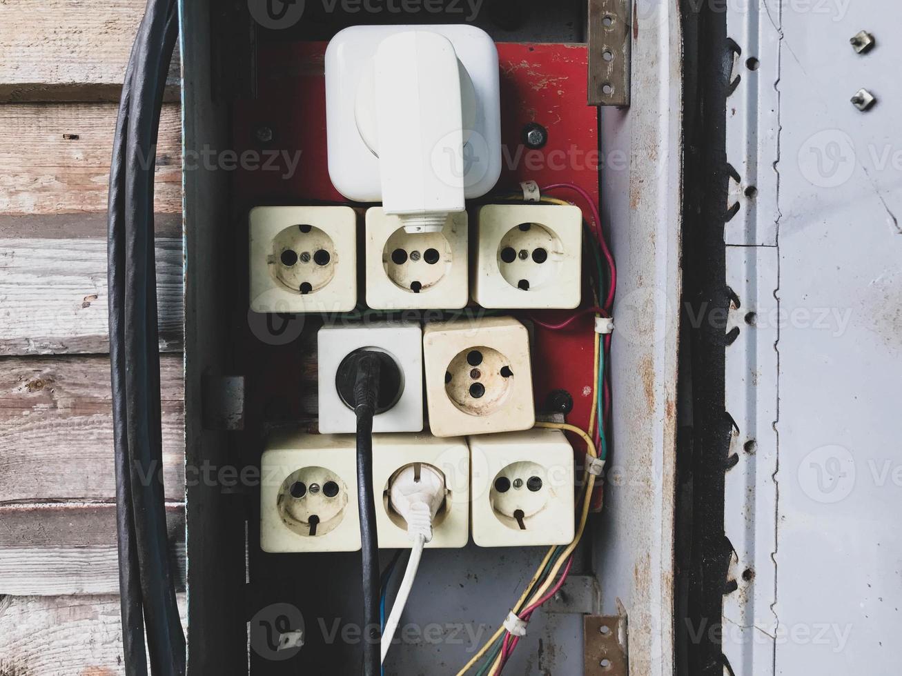 switch box. homemade shield with sockets for power lines. DIY wiring. many white rosettes, the largest white on top. creation of a high-voltage power line photo