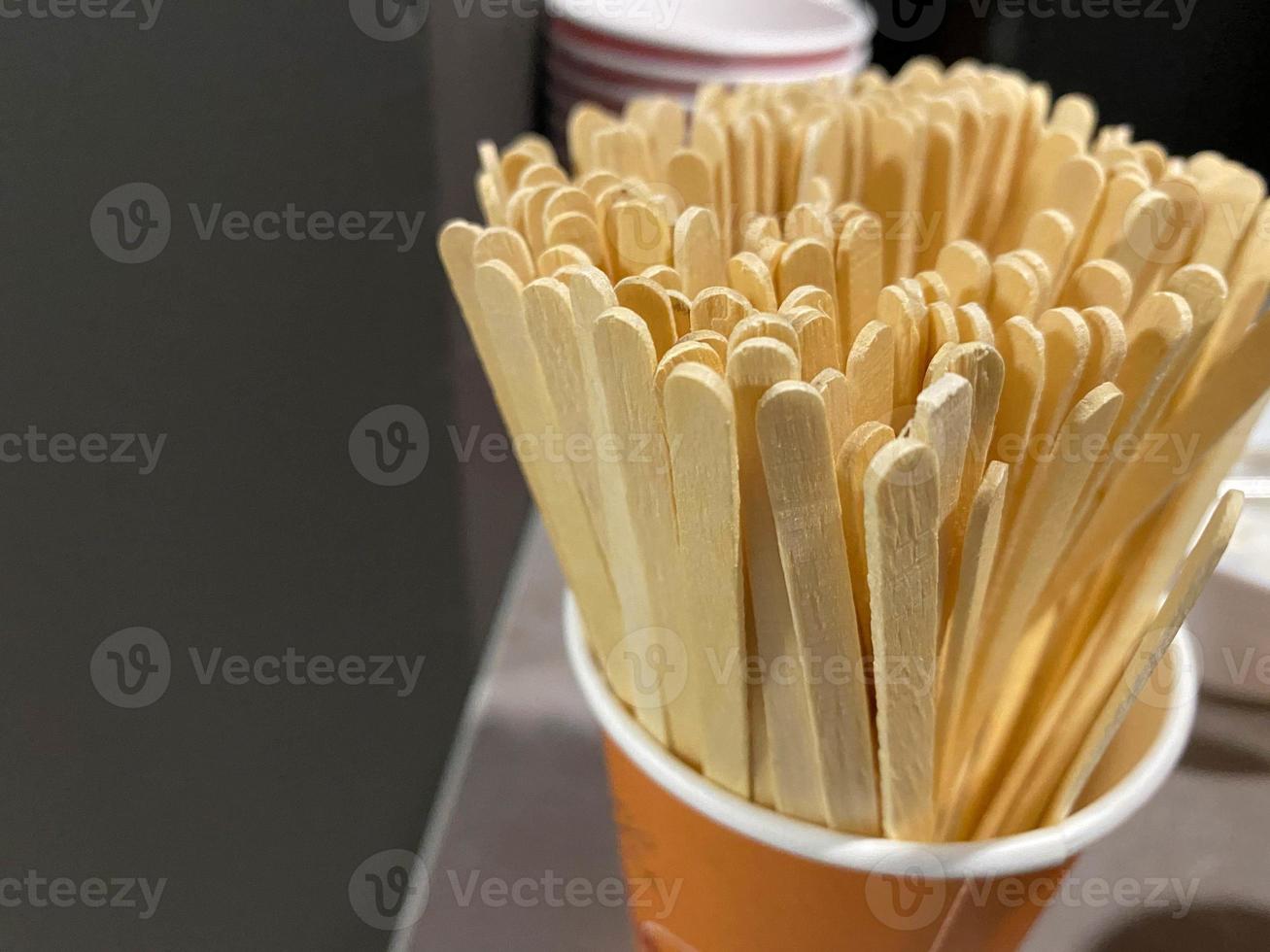 Wooden stick for mixing coffee. Selective focus photo