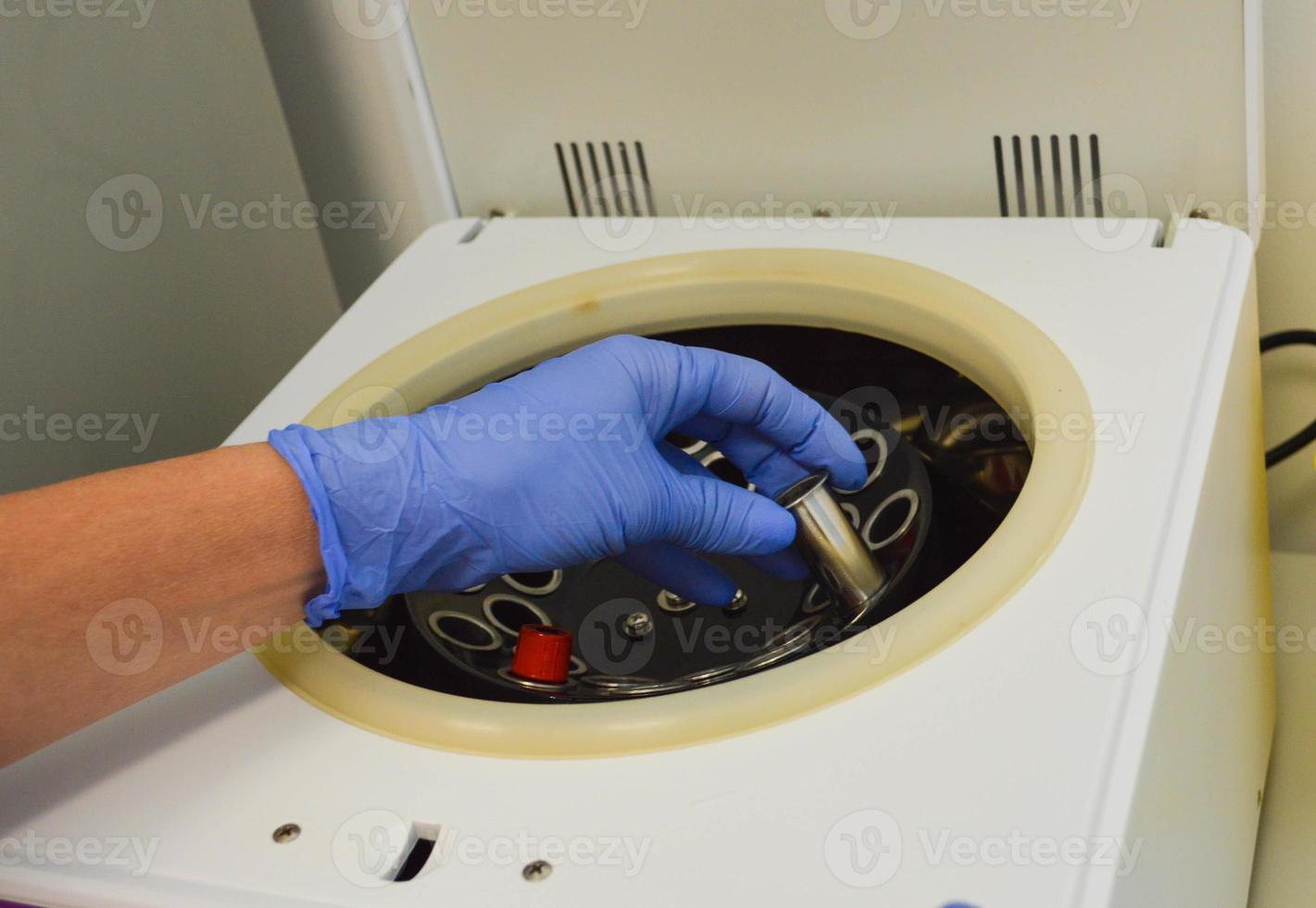 Lab man puts in centrifuge tube with blood for testing coronavirus.Tests for detection virus Sars-cov-2 causing covid-19 and specific antibodies IgM and IgG meaning that exists immunity.Vaccine photo