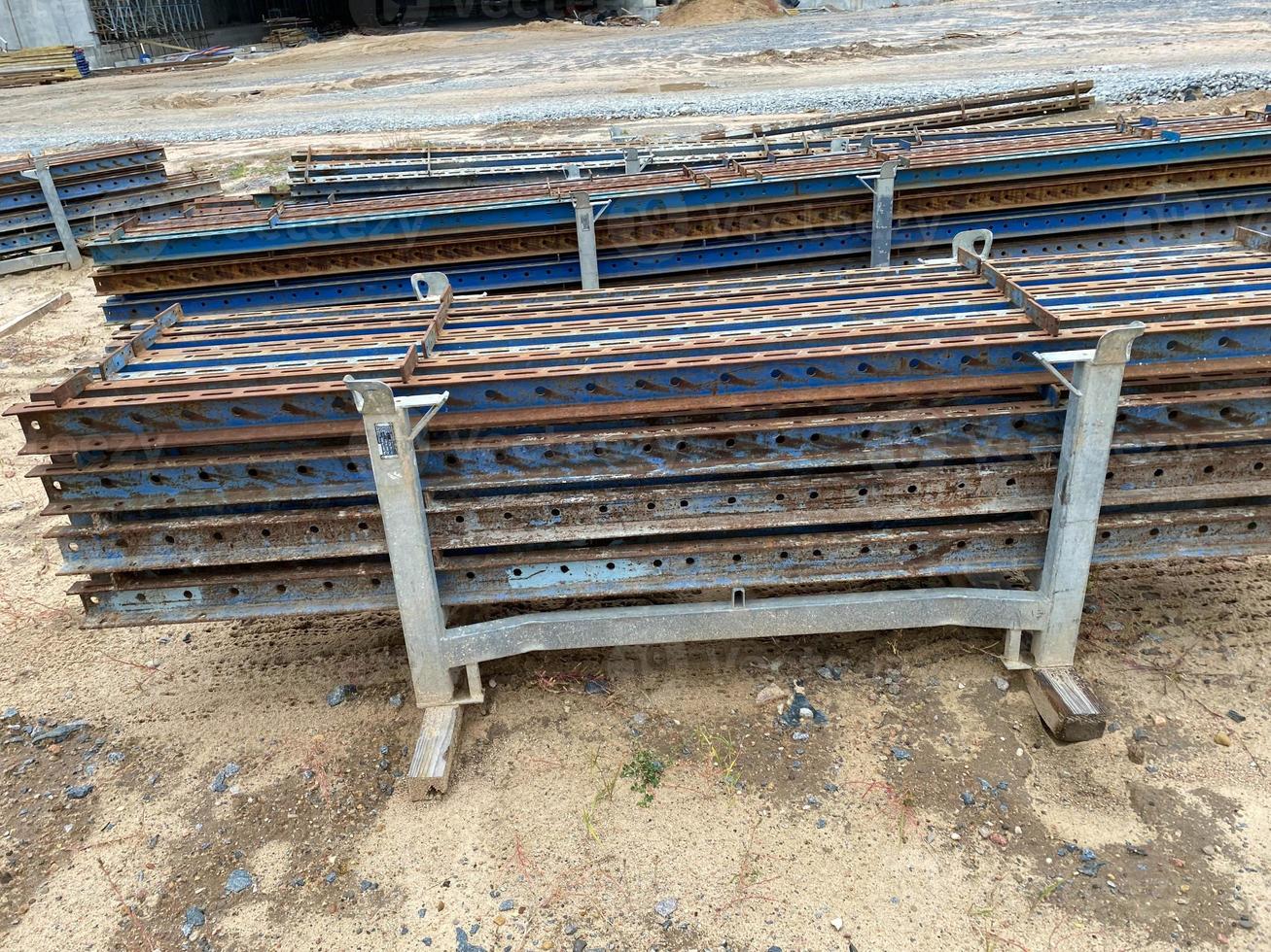Iron parts of the workpiece for laying railway tracks metal structures in a heap at an industrial plant photo