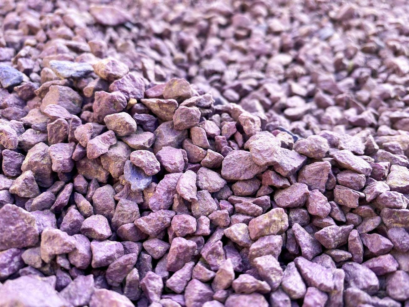 purple color stones, texture. heaping of stones, decorative elements for the improvement of the city and residential area. background with stones, small rocks photo
