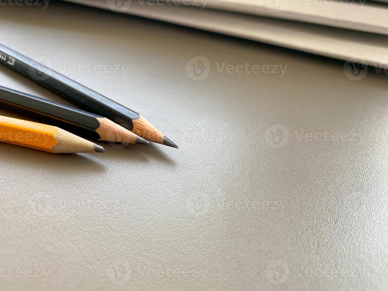 Three pencils lie sharply sharpened next to folders with sheets of paper and documents on the working business desk in the office. Stationery photo